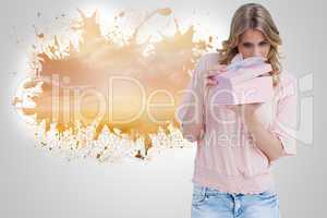 Composite image of curious young woman holding a gift while open