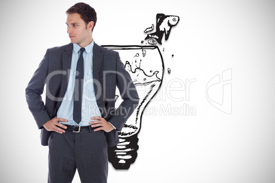 Composite image of serious businessman with hands on hips