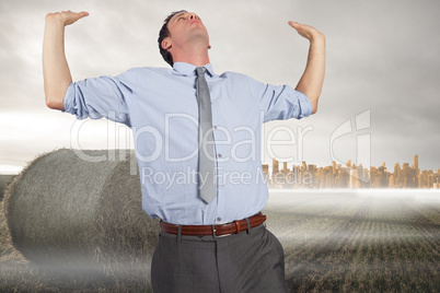 Composite image of businessman standing with hands up