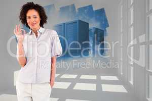 Composite image of young businesswoman showing okay sign