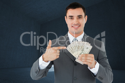 Composite image of businessman pointing at bank notes in his han