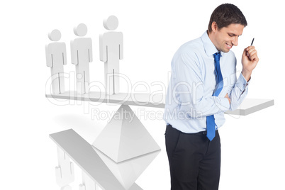 Composite image of thinking businessman holding pen