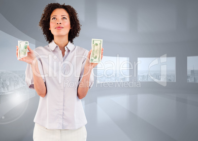 Composite image of serious businesswoman holding dollars and loo
