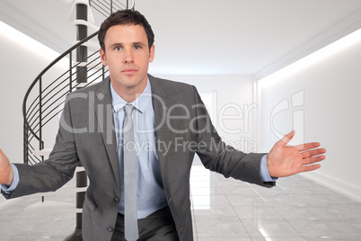 Composite image of businessman posing with hands out