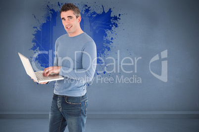 Composite image of man using a laptop