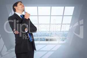 Composite image of thinking businessman holding pen