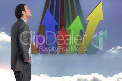 Composite image of smiling businessman with hand on hip