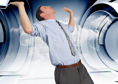 Composite image of businessman standing with hands up