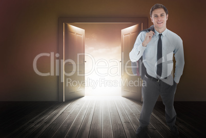 Composite image of smiling businessman holding his jacket