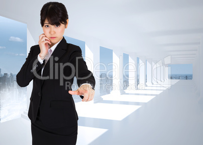 Composite image of thoughtful businesswoman pointing