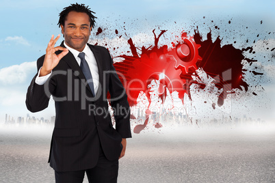 Composite image of businessman showing okay sign