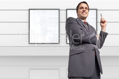 Composite image of thoughtful businessman holding pen