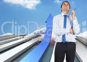 Composite image of thinking businessman holding pen