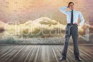 Composite image of thinking businessman with hand on head