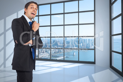 Composite image of thinking businessman holding pen