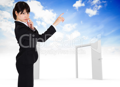 Composite image of thoughtful businesswoman pointing