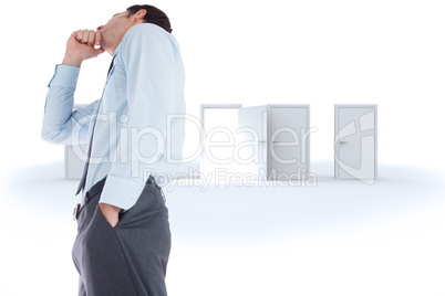 Composite image of thoughtful businessman with hand on chin Composite image of thoughtful businessman with hand on chin