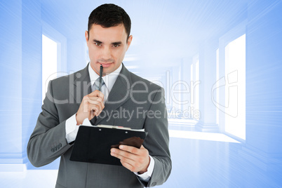 Composite image of businessman with pen and clipboard