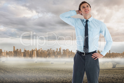 Composite image of thinking businessman with hand on head