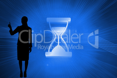 Composite image of shiny hourglass on blue background