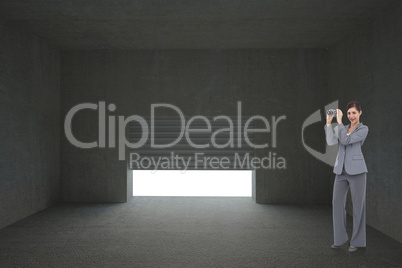 Composite image of businesswoman posing with binoculars