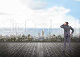 Composite image of thinking businessman scratching head