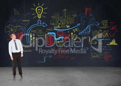 Composite image of businessman looking up