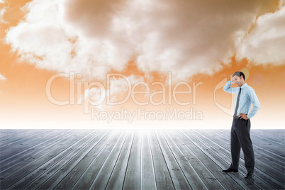 Composite image of thoughtful businessman with hand on head