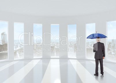 Composite image of businessman holding umbrella