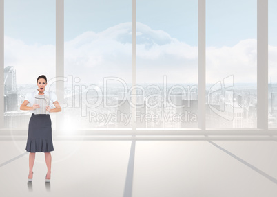 Composite image of shocked stylish businesswoman holding newspap