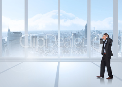 Composite image of stressed businessman with hands on head