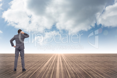 Composite image of thinking businessman scratching head