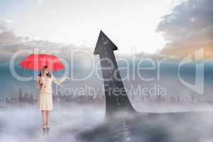 Composite image of attractive businesswoman holding red umbrella