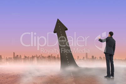 Composite image of asian businessman pointing