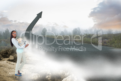 Composite image of side view of young woman carrying a pile of b