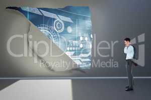 Composite image of serious businessman holding his jacket