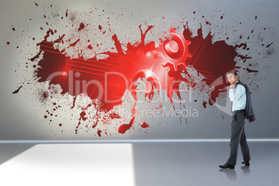 Composite image of serious businessman holding his jacket