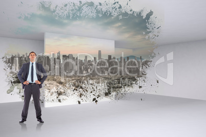 Composite image of serious businessman with hands on hips