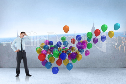 Composite image of thoughtful businessman with hand on head