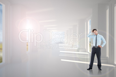 Composite image of thoughtful businessman with hand on head