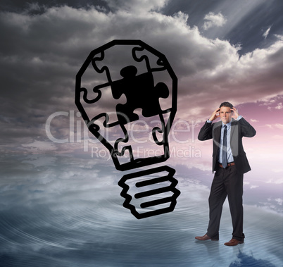 Composite image of stressed businessman with hands on head