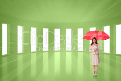 Composite image of attractive businesswoman holding red umbrella