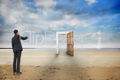 Composite image of asian businessman pointing