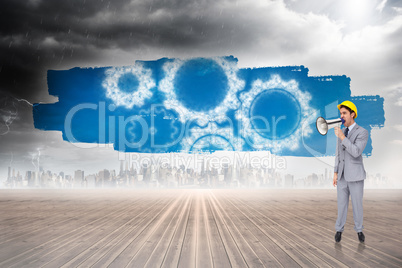 Composite image of young architect yelling with a megaphone