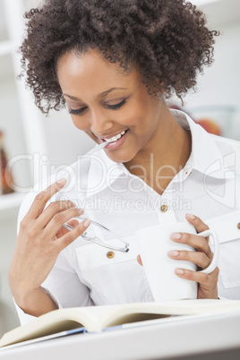 african american girl woman reading drinking coffee tea