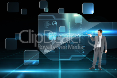 Composite image of businessman looking at what he is presenting