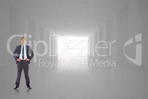 Composite image of serious businessman with hands on hips