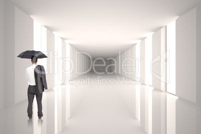 Composite image of businessman standing back to camera holding u