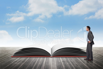Composite image of smiling businessman with hands on hips Composite image of smiling businessman with hands on hips