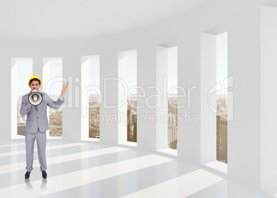 Composite image of architect with hard hat shouting with a megap